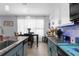 Modern kitchen featuring stainless steel appliances and white upper cabinets with a view into the dining area at 951 Nodding Shade Dr, Brooksville, FL 34604