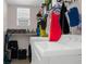 Functional laundry room with a window, storage space, washer, dryer, and laundry supplies at 951 Nodding Shade Dr, Brooksville, FL 34604