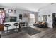 A well lit living room featuring a comfortable gray sofa and hard surface floors at 951 Nodding Shade Dr, Brooksville, FL 34604