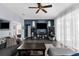 Comfortable living room featuring a ceiling fan, hard surface floors, and ample sunlight at 951 Nodding Shade Dr, Brooksville, FL 34604