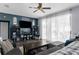 Comfortable living room featuring a ceiling fan, hard surface floors, and ample sunlight at 951 Nodding Shade Dr, Brooksville, FL 34604