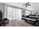 Spacious living room with hardwood floors, a ceiling fan, and large windows covered with sheer curtains at 951 Nodding Shade Dr, Brooksville, FL 34604