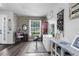 A well lit living room featuring a gray brick wall and hard surface floors at 951 Nodding Shade Dr, Brooksville, FL 34604