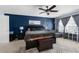 Bedroom featuring a spacious bed, stylish ceiling fan, and a bright window, creating a luxurious and inviting sanctuary at 951 Nodding Shade Dr, Brooksville, FL 34604