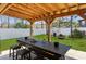 This covered patio area includes a large table and barstool seating at 951 Nodding Shade Dr, Brooksville, FL 34604