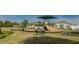 Community playground with modern slides and swings amidst lush landscaping and manicured lawns at 951 Nodding Shade Dr, Brooksville, FL 34604