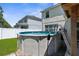 Above ground pool in backyard with ladder and a view of the home at 951 Nodding Shade Dr, Brooksville, FL 34604