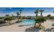 Resort-style pool area featuring ample lounge seating, tropical landscaping and clear blue skies at 951 Nodding Shade Dr, Brooksville, FL 34604
