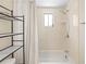 Bathtub with white shower curtain, modern fixtures, and tile surround at 9811 Hidden Ln # 2, Port Richey, FL 34668