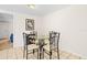 Simple dining area with glass table, seating for four, and tile flooring at 9811 Hidden Ln # 2, Port Richey, FL 34668