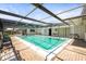 Enclosed swimming pool with clear blue water and lounge seating at 9811 Hidden Ln # 2, Port Richey, FL 34668