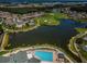 Overhead view of a community featuring a golf course, lake, pool and various amenities, creating a vibrant living experience at 1013 Sweet Jasmine Dr, Trinity, FL 34655
