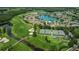 Stunning aerial showcasing a community golf course with surrounding homes and beautiful lake at 1013 Sweet Jasmine Dr, Trinity, FL 34655