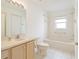 Neutral bathroom featuring a sink, toilet, and tub with a shower and safety bar at 1013 Sweet Jasmine Dr, Trinity, FL 34655