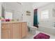 Bathroom with a neutral vanity, toilet, and shower/tub combo with a decorative curtain at 1013 Sweet Jasmine Dr, Trinity, FL 34655
