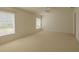 Expansive bedroom with neutral carpet and large windows, offering a serene and comfortable retreat at 1013 Sweet Jasmine Dr, Trinity, FL 34655