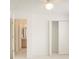 Spacious bedroom with an open closet and view of a bathroom through the door at 1013 Sweet Jasmine Dr, Trinity, FL 34655