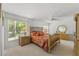 Bedroom with wood frame bed and dresser sets, bright natural light from a window, and ceiling fan at 1013 Sweet Jasmine Dr, Trinity, FL 34655