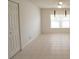 Well-lit bedroom with tile flooring and a ceiling fan, providing a neutral and comfortable space at 1013 Sweet Jasmine Dr, Trinity, FL 34655