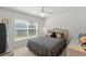 Bedroom with neutral walls and a plush bed with a woven headboard and side tables at 1013 Sweet Jasmine Dr, Trinity, FL 34655