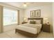 Cozy bedroom with a bed, nightstands, lamps, and artwork on the wall at 1013 Sweet Jasmine Dr, Trinity, FL 34655