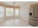 Eat-in kitchen featuring tile floors, plenty of windows, and stainless refrigerator at 1013 Sweet Jasmine Dr, Trinity, FL 34655