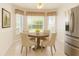 Cozy dining space features a round table, seating for four and view of outside at 1013 Sweet Jasmine Dr, Trinity, FL 34655