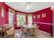 Bright dining area featuring a round table, comfortable chairs, and views of the surrounding greenery at 1013 Sweet Jasmine Dr, Trinity, FL 34655
