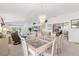 Elegant dining area with a modern chandelier, views into the living room and the kitchen pass-through at 1013 Sweet Jasmine Dr, Trinity, FL 34655