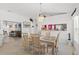 Cozy dining area with views of both the living room and the kitchen with adjacent stainless steel appliances at 1013 Sweet Jasmine Dr, Trinity, FL 34655