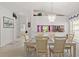 Bright dining area with modern chandelier and a pass-through to a kitchen with stainless steel appliances at 1013 Sweet Jasmine Dr, Trinity, FL 34655