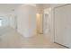 Bright hallway with tile floors, closet, and access to various rooms in the house at 1013 Sweet Jasmine Dr, Trinity, FL 34655