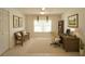 Functional home office with natural light, desk, and shelving, creating a productive workspace at 1013 Sweet Jasmine Dr, Trinity, FL 34655