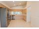 The kitchen features stainless appliances, and ample cabinet and counter space at 1013 Sweet Jasmine Dr, Trinity, FL 34655