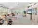 Bright living room with a neutral color scheme, plush carpet, and sliding glass doors to the patio at 1013 Sweet Jasmine Dr, Trinity, FL 34655