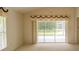 Bright living area featuring neutral carpet, large windows, and sliding doors, perfect for relaxation at 1013 Sweet Jasmine Dr, Trinity, FL 34655