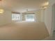 Spacious living area with carpet and ample natural light, providing a comfortable and inviting space at 1013 Sweet Jasmine Dr, Trinity, FL 34655