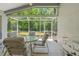 Relaxing screened patio featuring tiled floor, natural light and outdoor seating at 1013 Sweet Jasmine Dr, Trinity, FL 34655