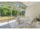 Relaxing screened patio featuring tiled floor, natural light and outdoor seating at 1013 Sweet Jasmine Dr, Trinity, FL 34655