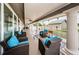 Covered patio with comfortable lounge chairs and tables offers a relaxing space with views of the surrounding community at 1013 Sweet Jasmine Dr, Trinity, FL 34655