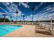 Community pool and lounge chairs offering residents a place to relax with views of the scenic lake in the distance at 1013 Sweet Jasmine Dr, Trinity, FL 34655