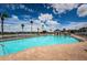 Large swimming pool with adjacent patio and lounge chairs under clear skies for a relaxing outdoor experience at 1013 Sweet Jasmine Dr, Trinity, FL 34655