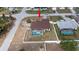 Aerial view of a beautiful fenced home with a screened-in pool and well-kept backyard at 1034 Aladdin Rd, Spring Hill, FL 34609