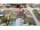 Aerial view of a lovely property with a pool in the fenced backyard with room for entertaining at 1034 Aladdin Rd, Spring Hill, FL 34609