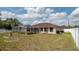 Fenced backyard with pool and screened-in patio, offering a private and relaxing outdoor space at 1034 Aladdin Rd, Spring Hill, FL 34609