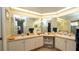Bathroom with dual sinks, a large vanity, ample counter space, and a large well-lit mirror at 1034 Aladdin Rd, Spring Hill, FL 34609