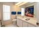Bright bathroom featuring white cabinets, a sink, and a tropical shower curtain at 1034 Aladdin Rd, Spring Hill, FL 34609