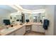 Bathroom features dual sinks, a vanity, ample counter space, and a large mirror at 1034 Aladdin Rd, Spring Hill, FL 34609