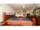 Generously sized bedroom provides lots of space, a ceiling fan, and beautiful hardwood floors at 1034 Aladdin Rd, Spring Hill, FL 34609