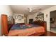 Spacious bedroom has a hardwood floor, a fan, and lots of natural light from a large picture window at 1034 Aladdin Rd, Spring Hill, FL 34609